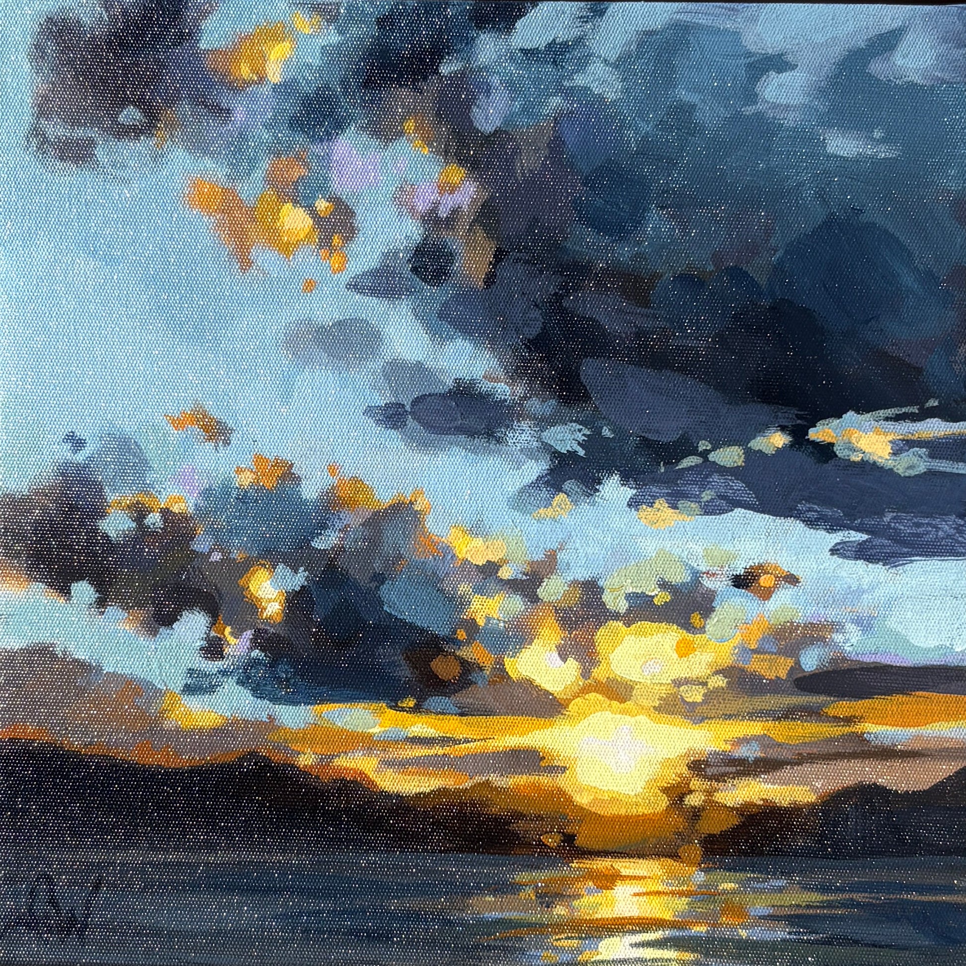 A square framed painting of a dramatic sunset over water, featuring dark blue and grey clouds with bright yellow light reflecting on the horizon.