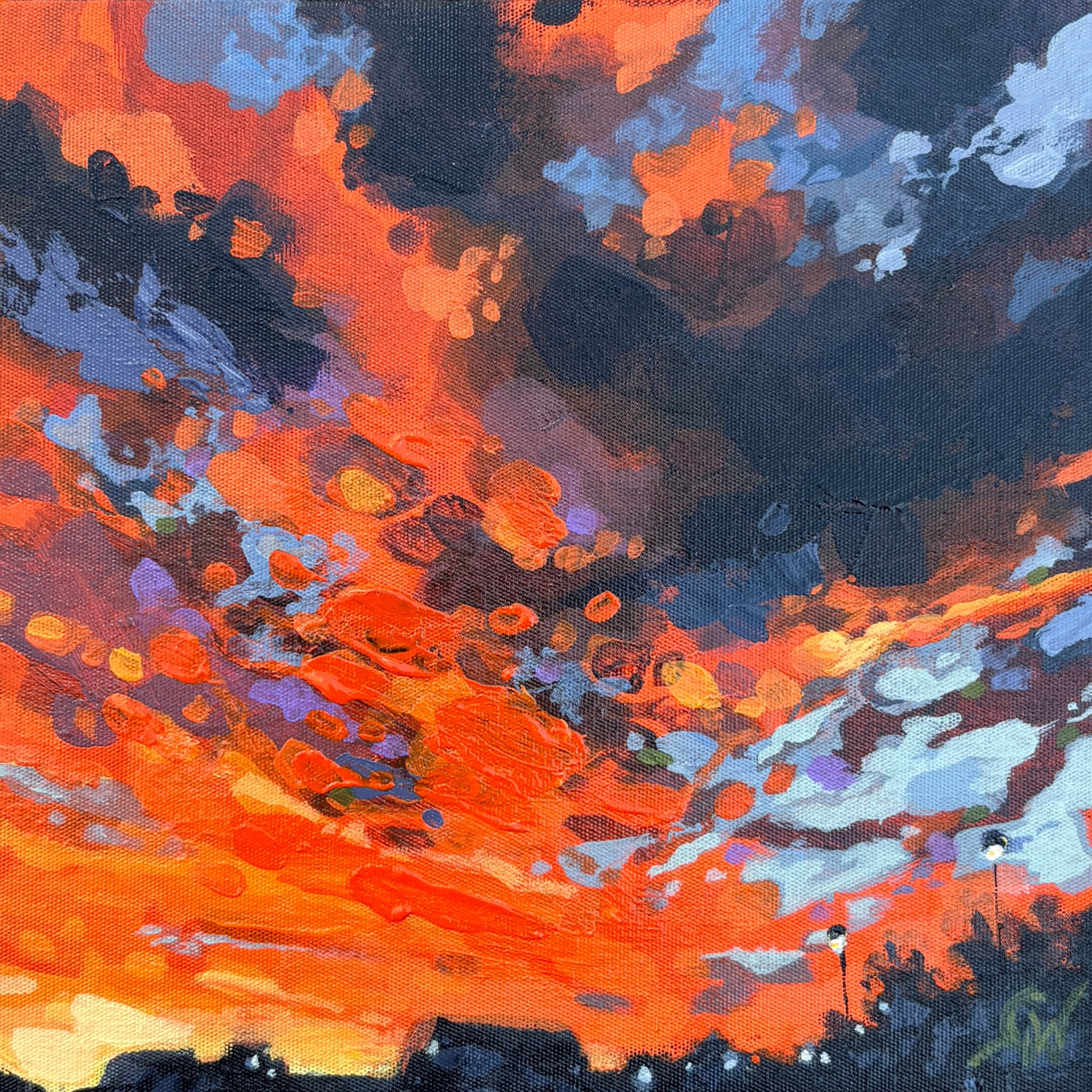 A square framed abstract painting featuring vibrant orange, red, black, and blue brushstrokes.