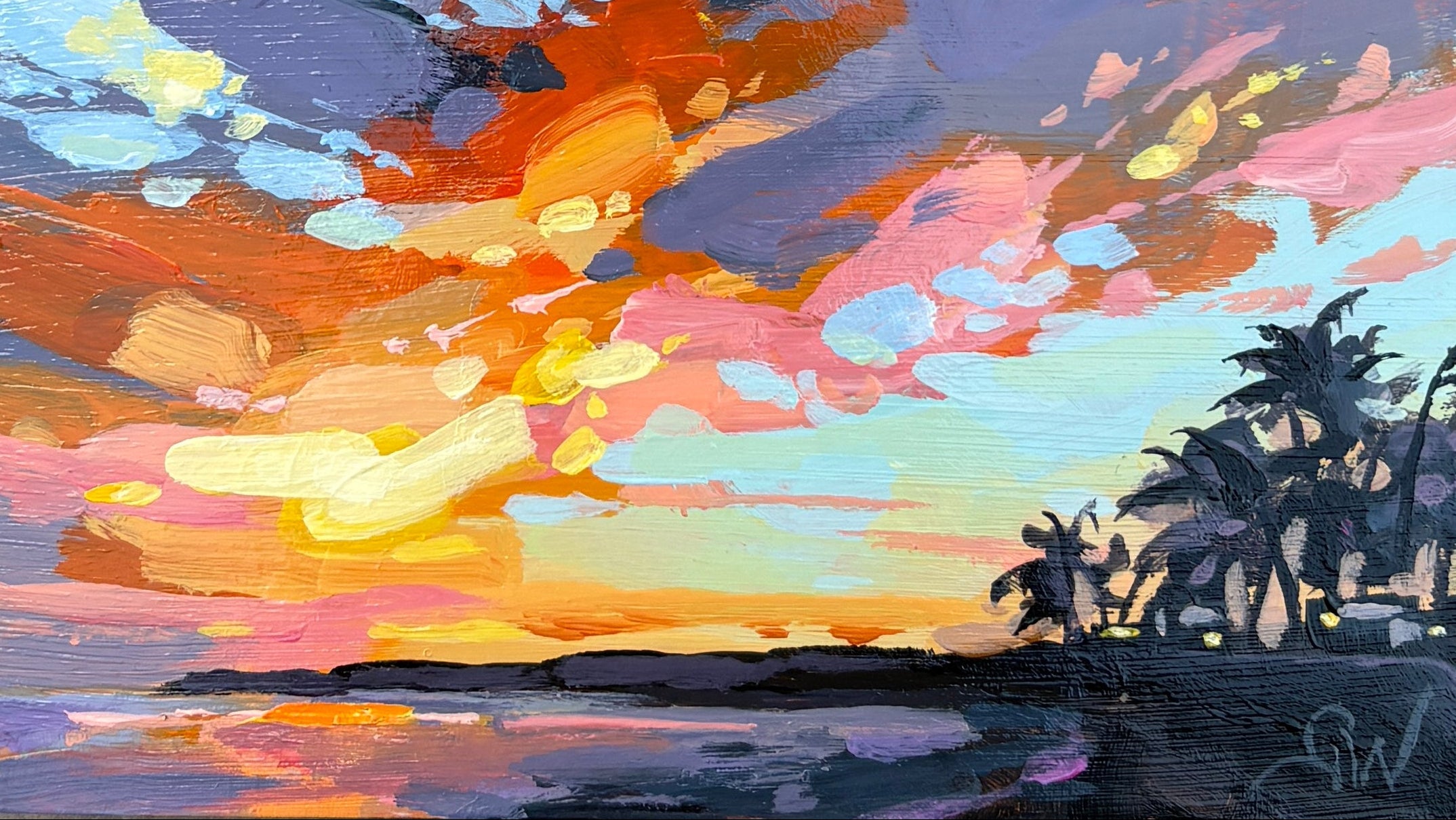 A small square canvas painting of a colorful sunset over water with palm trees, displayed on a textured gray stone surface.