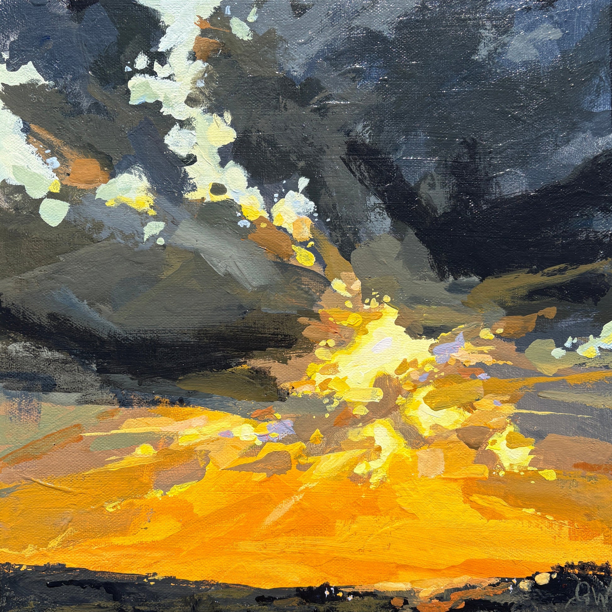 A framed abstract landscape painting on canvas, featuring a dramatic dark sky with white highlights and a bright yellow-orange glowing horizon, mounted on a textured light gray wall.